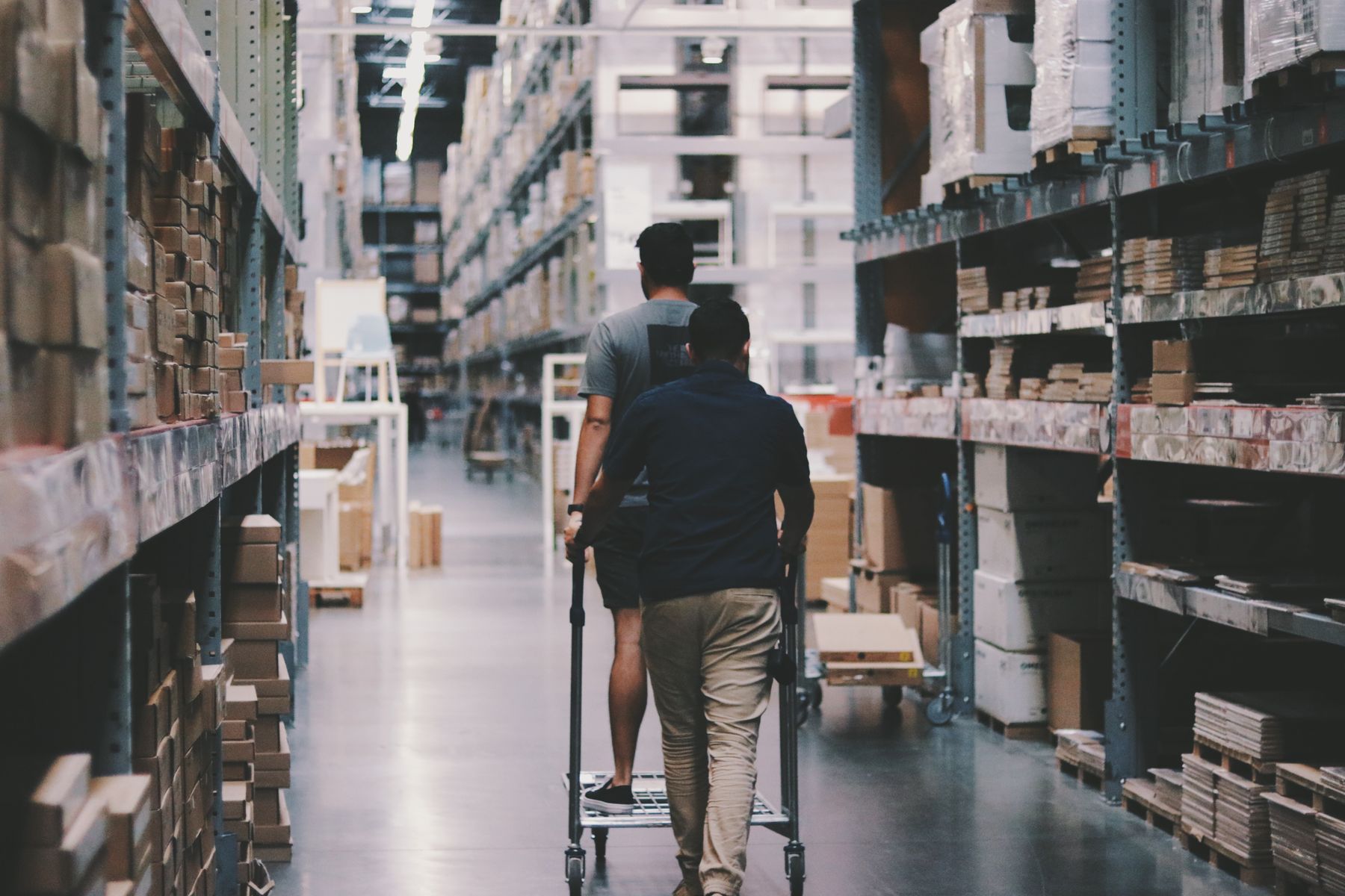 Warehouse workers moving goods through an aisle
